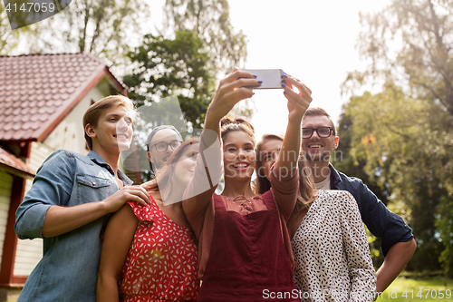 Image of friends taking selfie at party in summer garden