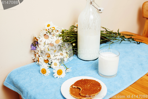 Image of Simply stylish wooden kitchen with bottle of milk and glass on t