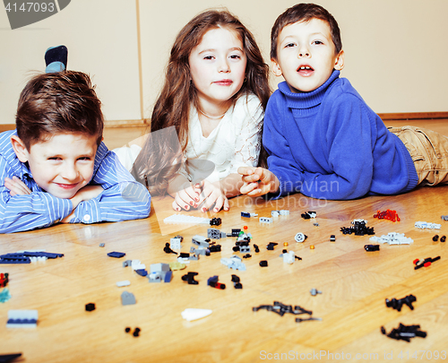 Image of funny cute children playing lego at home, boys and girl smiling, first education role lifestyle