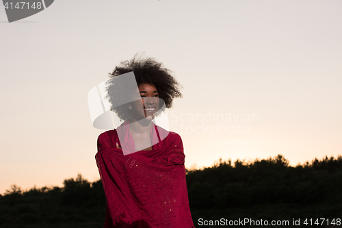 Image of outdoor portrait of a black woman with a scarf