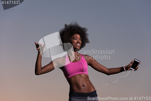 Image of young black girl dances outdoors