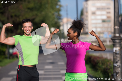 Image of portrait of young multietnic jogging couple ready to run