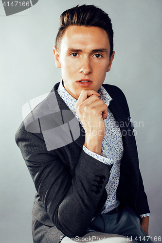 Image of young pretty business man standing on white background, modern hairstyle, posing emotional, lifestyle people concept