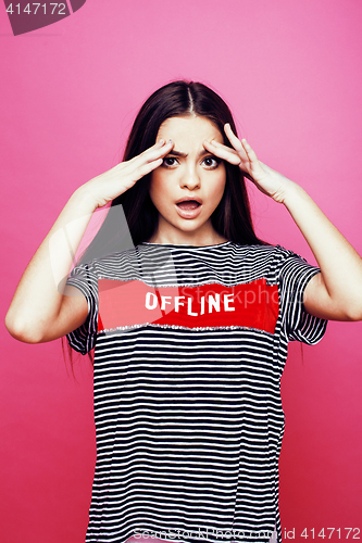 Image of young pretty teenage woman emotional posing on pink background, fashion lifestyle people concept 