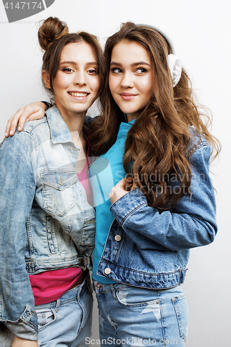 Image of lifestyle and people concept: Fashion portrait of two stylish sexy girls best friends, over white background. Happy time for fun.