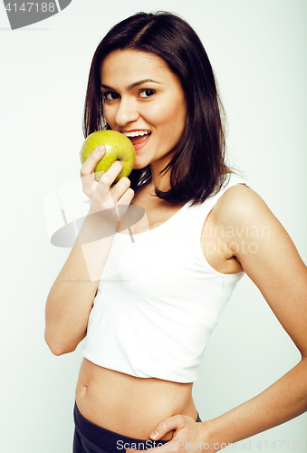 Image of portrait of sporty young woman with green apple isolated on white background