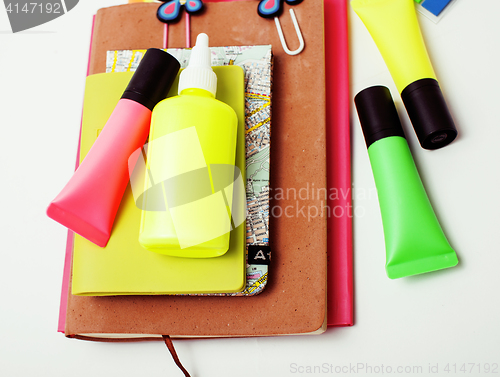 Image of business, education and technology concept - close up of notebook, paper stickers, pencil different stuff on white background