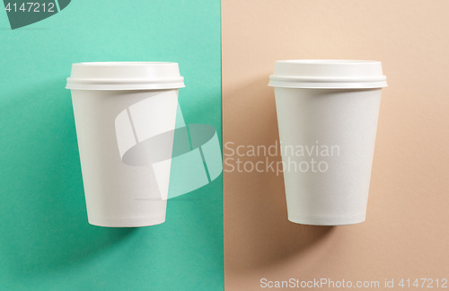 Image of two white take away coffee cups