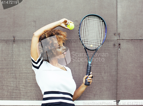 Image of young stylish mulatto afro-american girl playing tennis, sport healthy lifestyle people concept