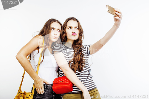 Image of two best friends teenage girls together having fun, posing emotional on white background, besties happy smiling, making selfie, lifestyle people concept