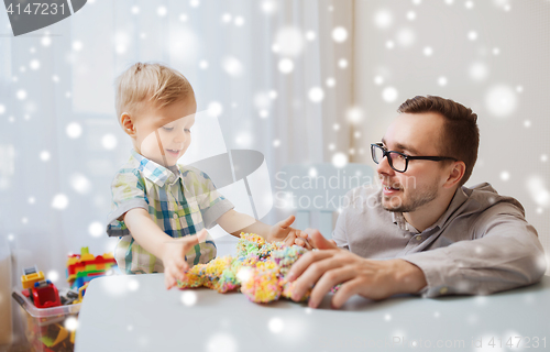 Image of father and son playing with ball clay at home