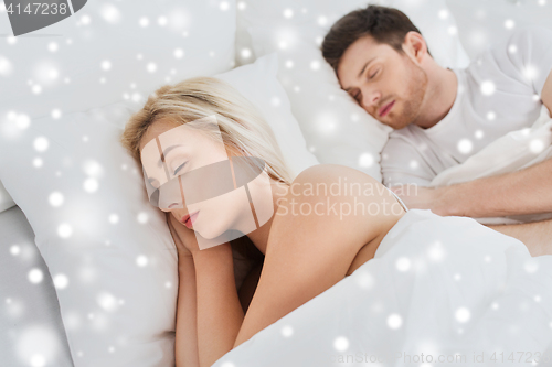 Image of happy couple sleeping in bed at home