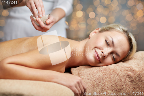 Image of close up of woman lying and having massage in spa