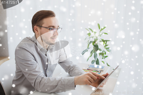 Image of happy creative male office worker with tablet pc