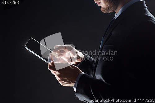 Image of close up of businessman with transparent tablet pc