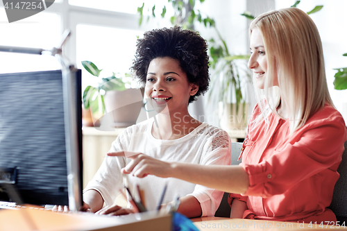 Image of happy women or students with computer in office