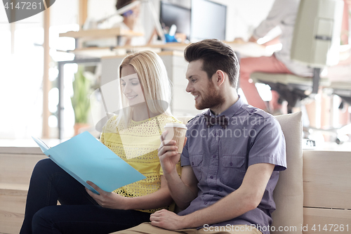 Image of office workers with folder and coffee