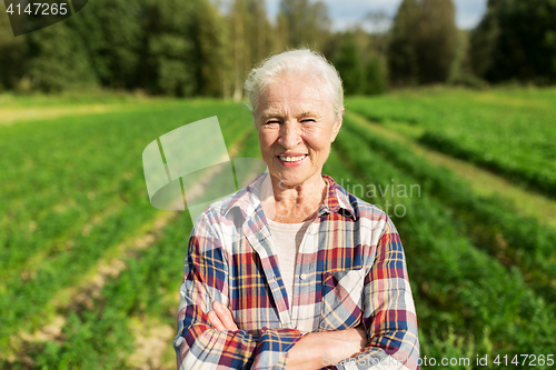 Image of happy senior woman at farm