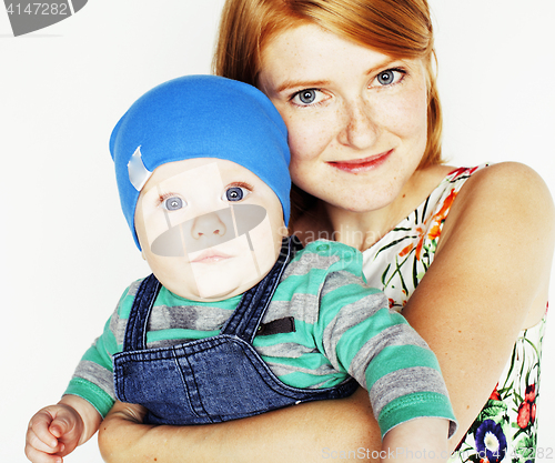 Image of young beauty mother with cute baby, red head happy modern family