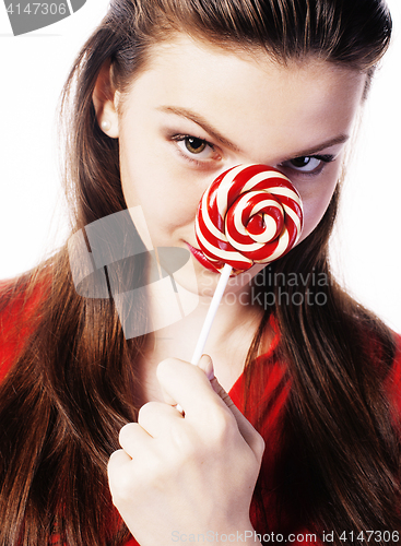 Image of young pretty brunette girl with red candy posing on white backgr