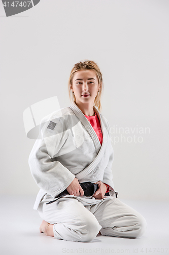 Image of The female judokas fighter posing on gray