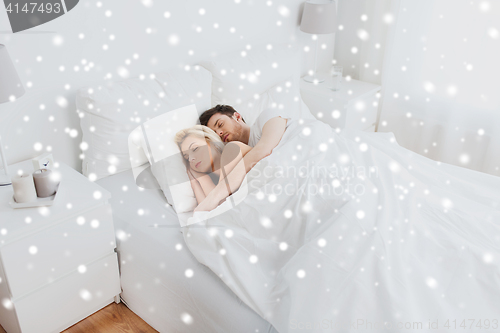 Image of happy couple sleeping in bed at home