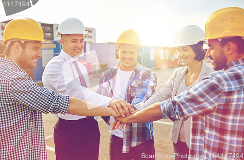 Image of builders and architects with hands on top