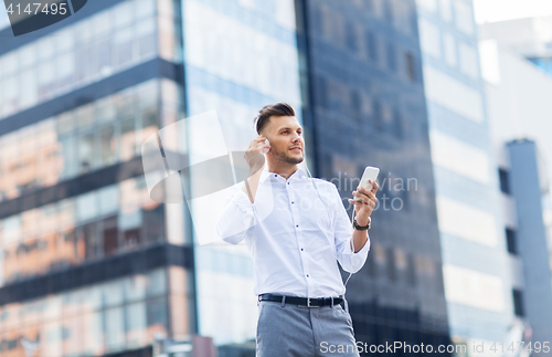 Image of man with headphones and smartphone listening music