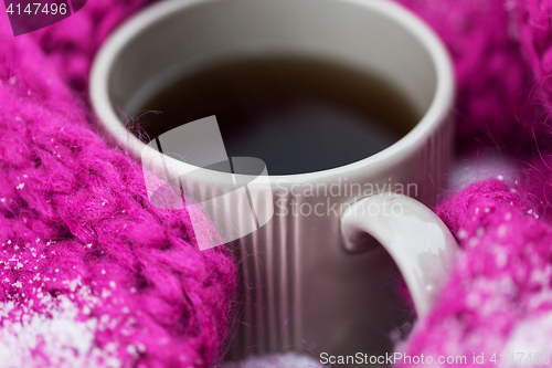 Image of close up of tea or coffee and winter scarf in snow