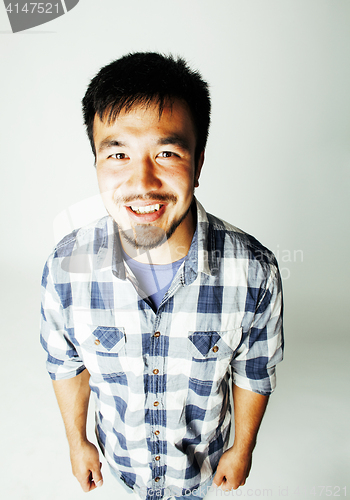 Image of young cute asian man on white background gesturing emotional, po