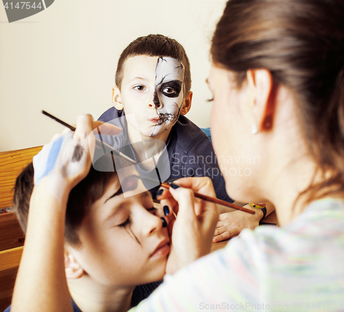 Image of little cute child making facepaint on birthday party, zombie Apo