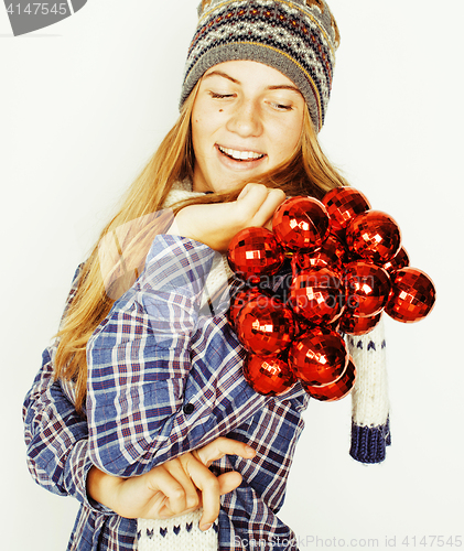 Image of young pretty blond teenage girl in winter hat and scarf on white