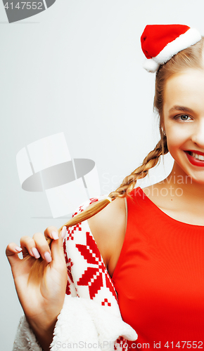 Image of young pretty happy smiling blond woman on christmas in santas red hat and holiday decorated plaid, lifestyle people concept