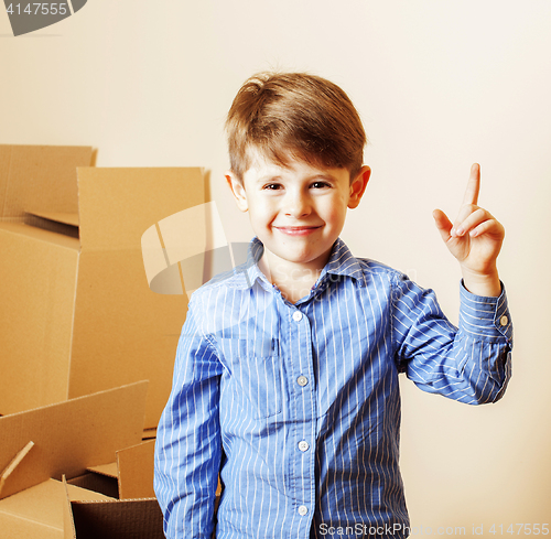 Image of little cute boy in empty room, remoove to new house. home alone,