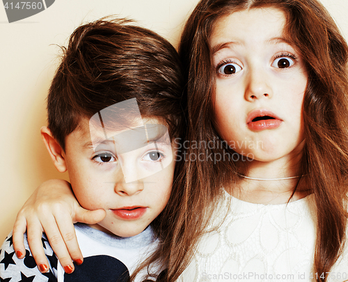 Image of little cute boy and girl hugging playing on white background, ha