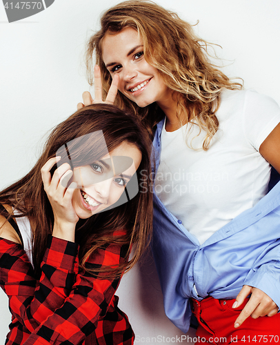 Image of two best friends teenage girls together having fun, posing emotional on white background, besties happy smiling, making selfie, lifestyle people concept