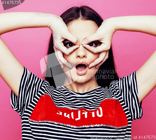 Image of young pretty teenage woman emotional posing on pink background, fashion lifestyle people concept