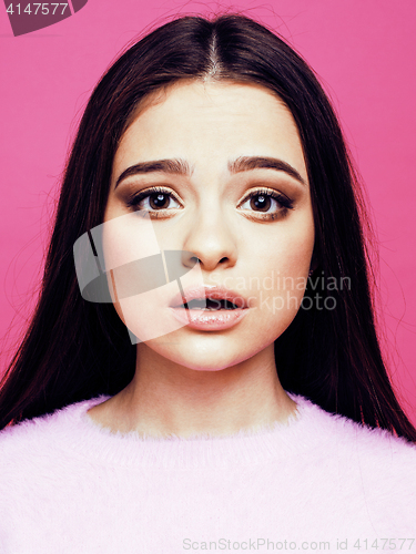 Image of young pretty teenage woman emotional posing on pink background, fashion lifestyle people concept