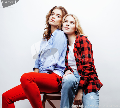 Image of two pretty blond woman having fun together on white background, mature mother and young teenage daughter, lifestyle people concept