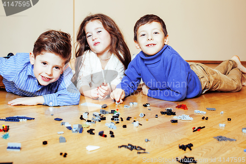 Image of funny cute children playing lego at home, boys and girl smiling, first education role lifestyle