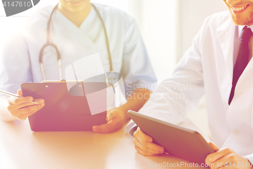 Image of doctors with tablet pc and clipboard at hospital