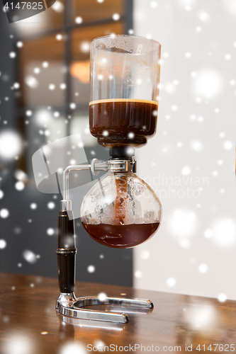 Image of close up of siphon vacuum coffee maker at shop