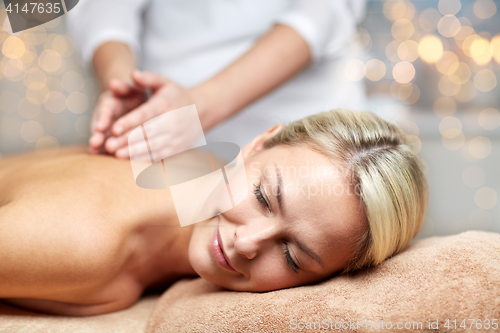 Image of close up of woman lying and having massage in spa