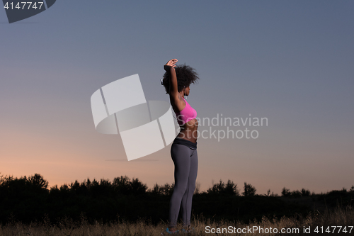 Image of black woman is doing stretching exercise relaxing and warm up