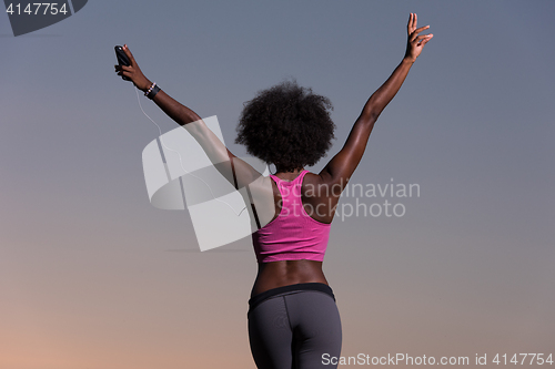 Image of young black girl dances outdoors