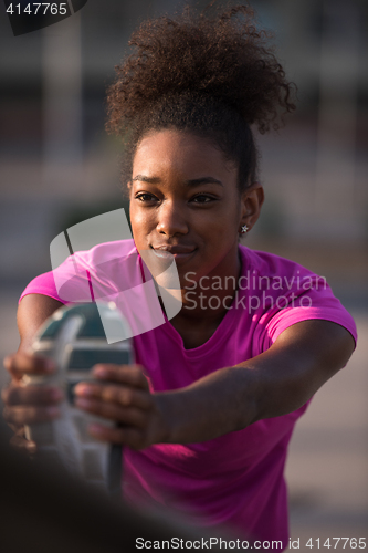 Image of African American woman doing warming up and stretching