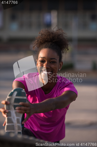 Image of African American woman doing warming up and stretching