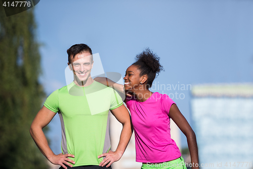 Image of portrait of young multietnic jogging couple ready to run