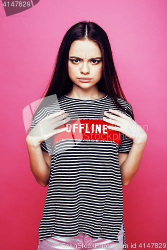Image of young pretty teenage woman emotional posing on pink background, fashion lifestyle people concept