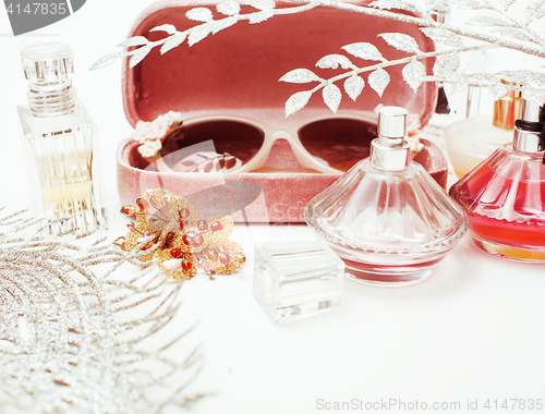 Image of Jewelry table with lot of girl stuff on it, little mess in cosmetic brushes, women interior concept, perfume elegance things